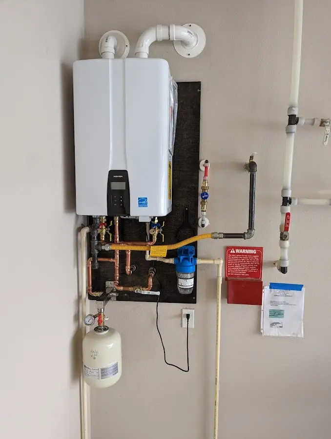 Professional plumber installing copper piping in a Rittman home